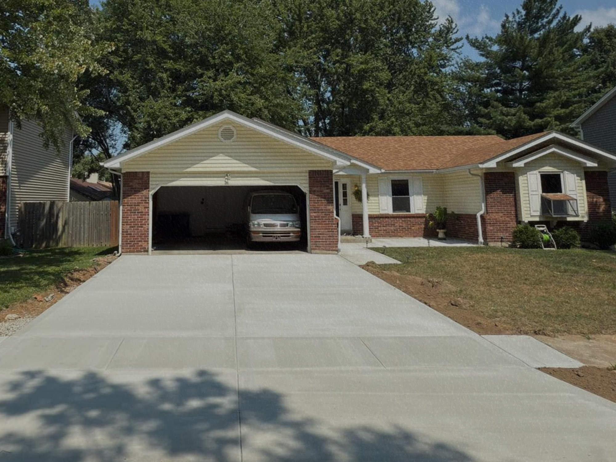 Fresh concrete driveway and ranch home — True Form Concrete