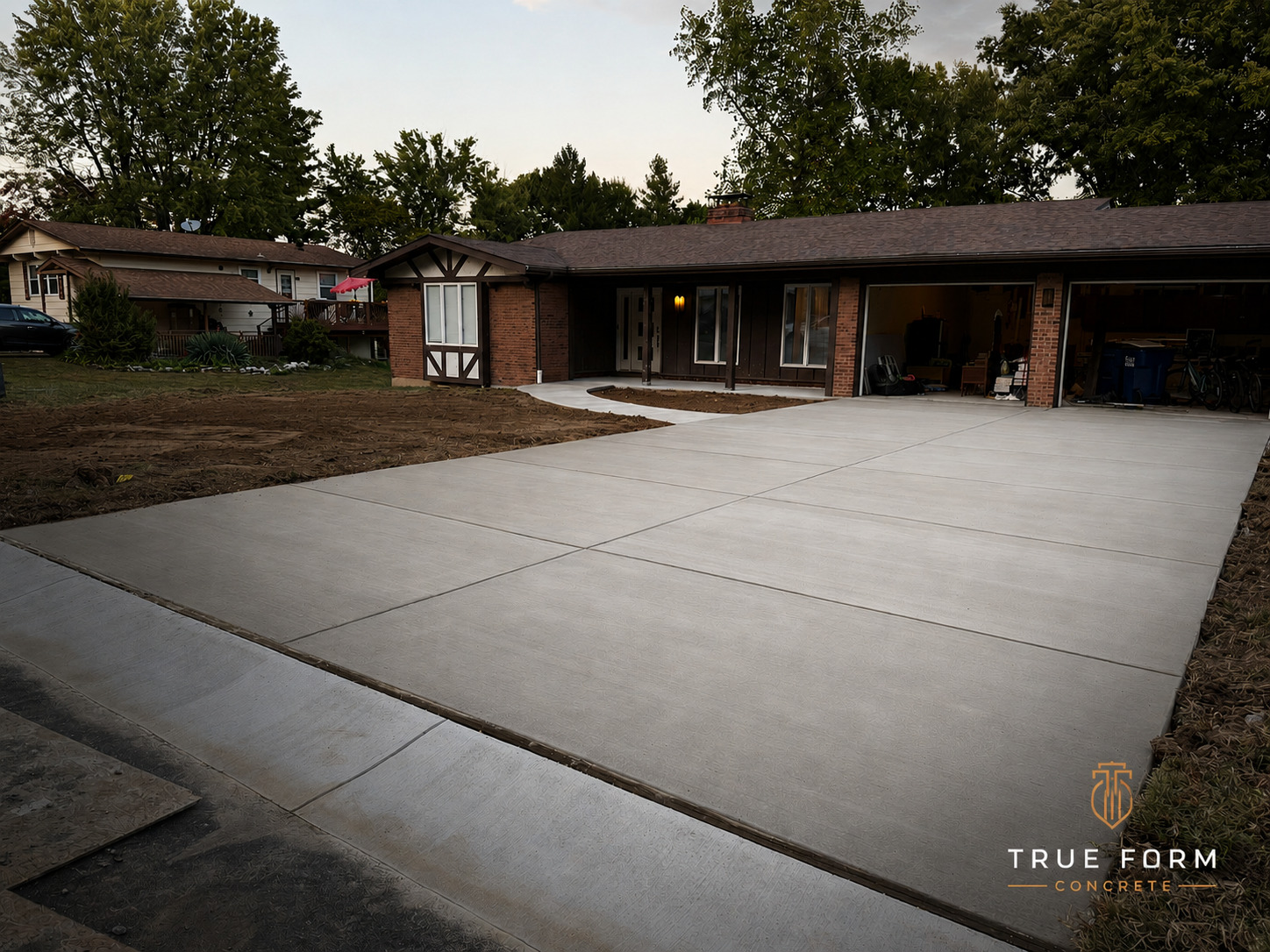 True Form Concrete brick ranch driveway pour at dusk
