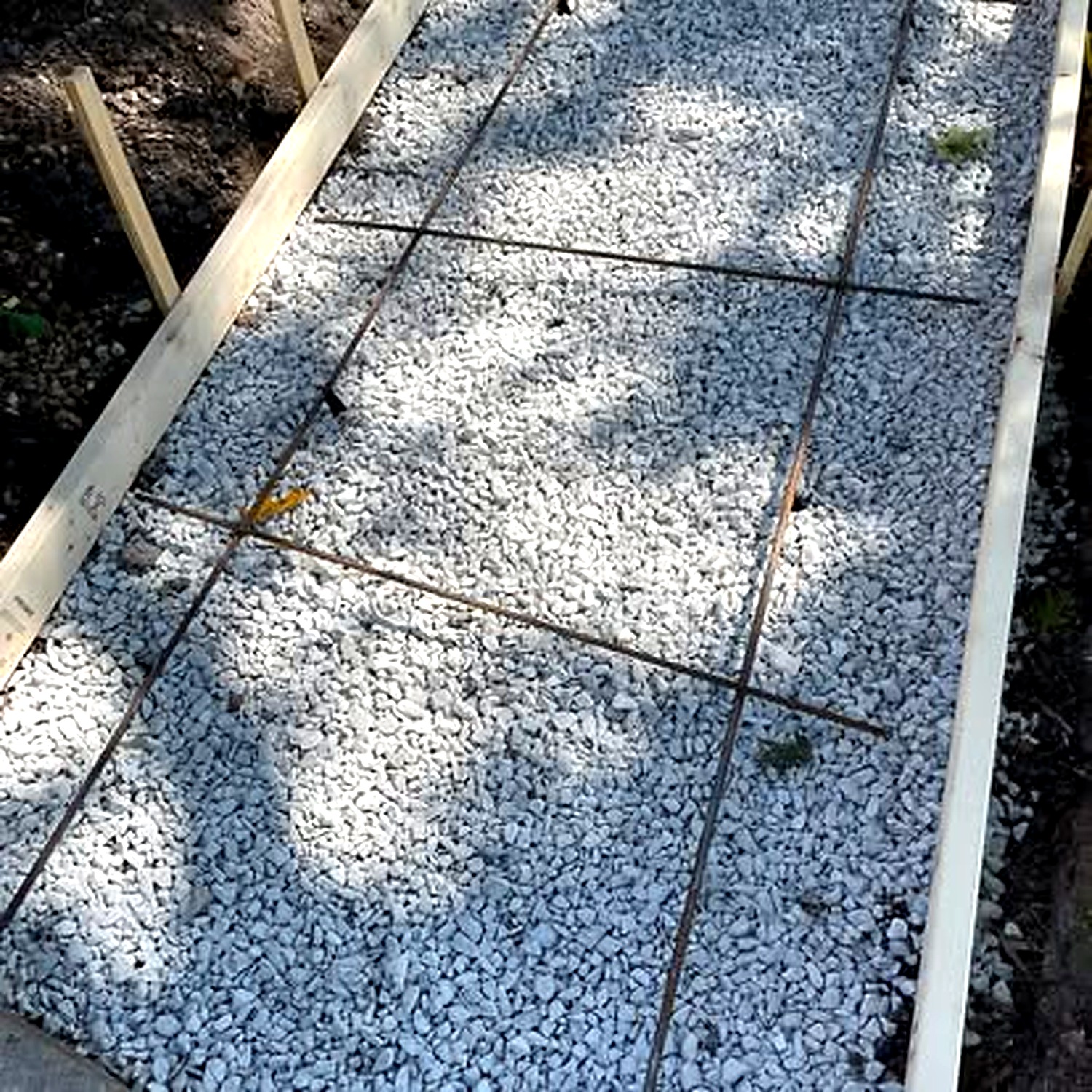 Concrete walkway and front entry at evening — True Form Concrete